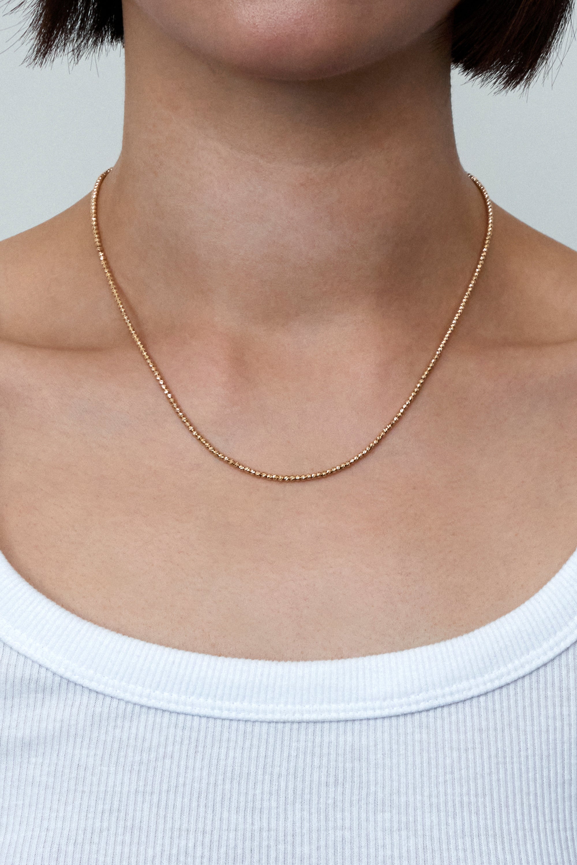 FACETED BALL CHAIN NECKLACE IN GOLD